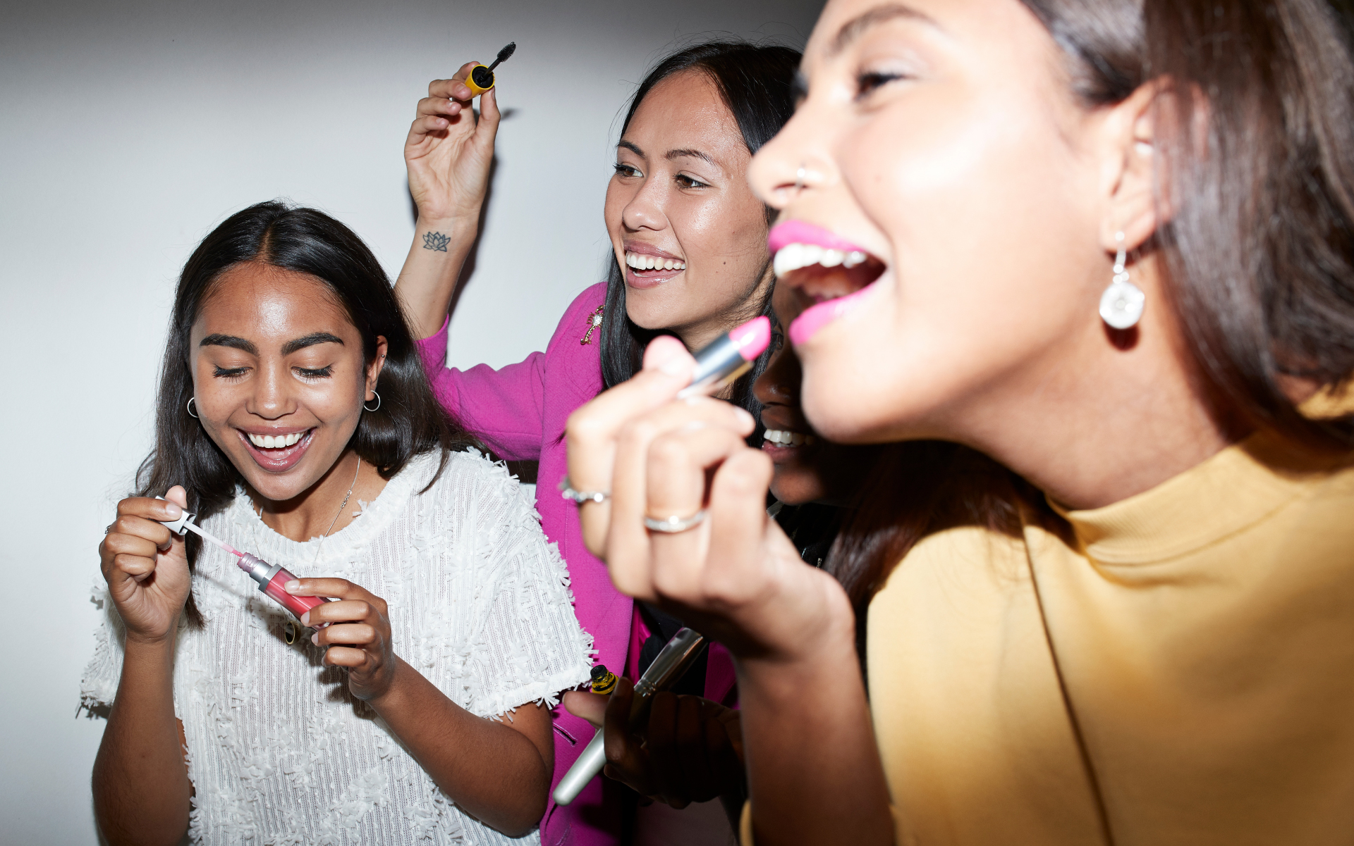 multicultural women doing makeup