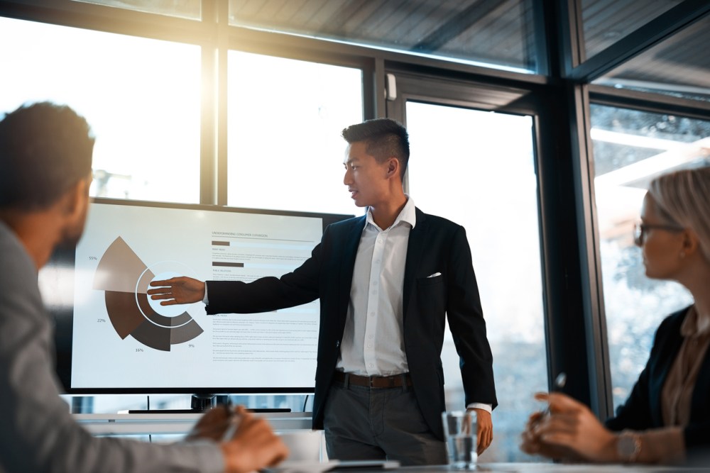 A man giving a work presentation on his company&rsquo;s trade promotion effectiveness.