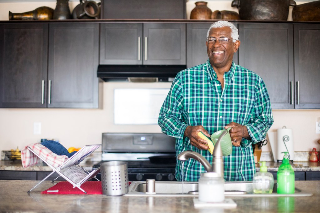 a man washing dishes in south africa