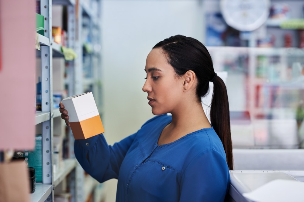 a woman looking for feminine products at a drug store