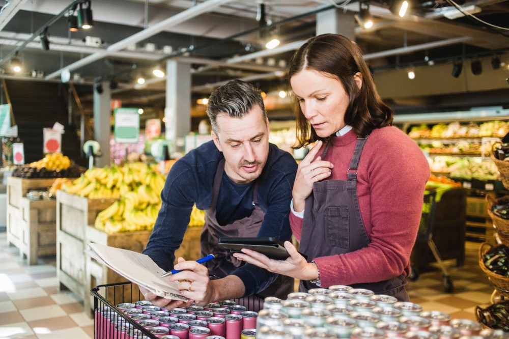 small business owners assess data of brand buyers