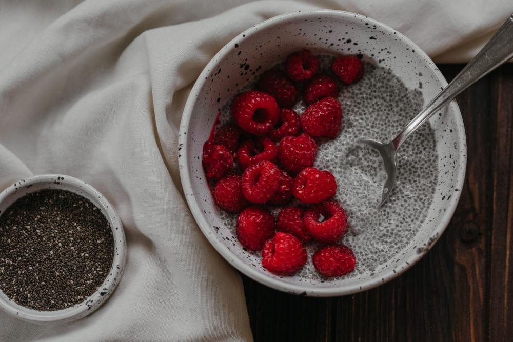 A plant-based meal of chia seeds and raspberries in a bowl