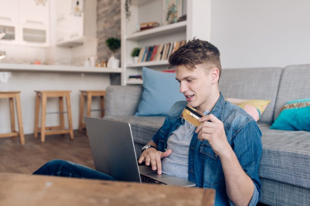 Young man buying something online during Deal Days