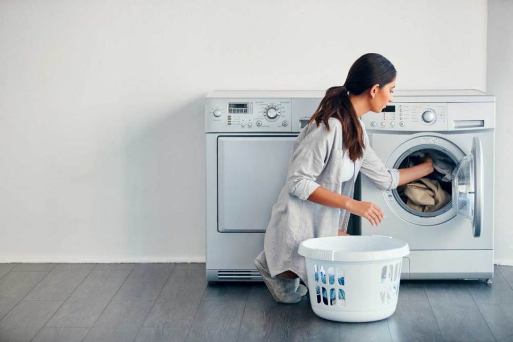Woman emptying clothes dryer
