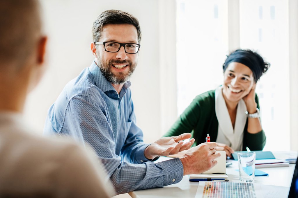 Meeting with 3 people in a conference room
