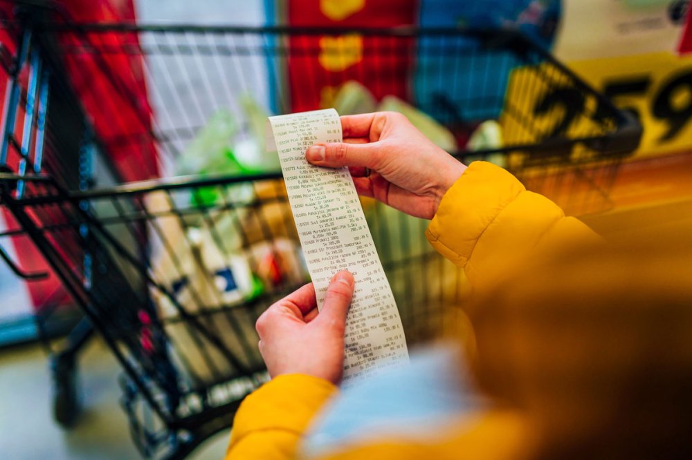 A woman reviews a receipt in store