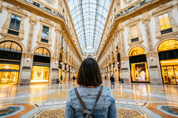 Beautiful young female tourist enjoying the view in Galleria Vittorio Emanuele II in Milan, Italy.
