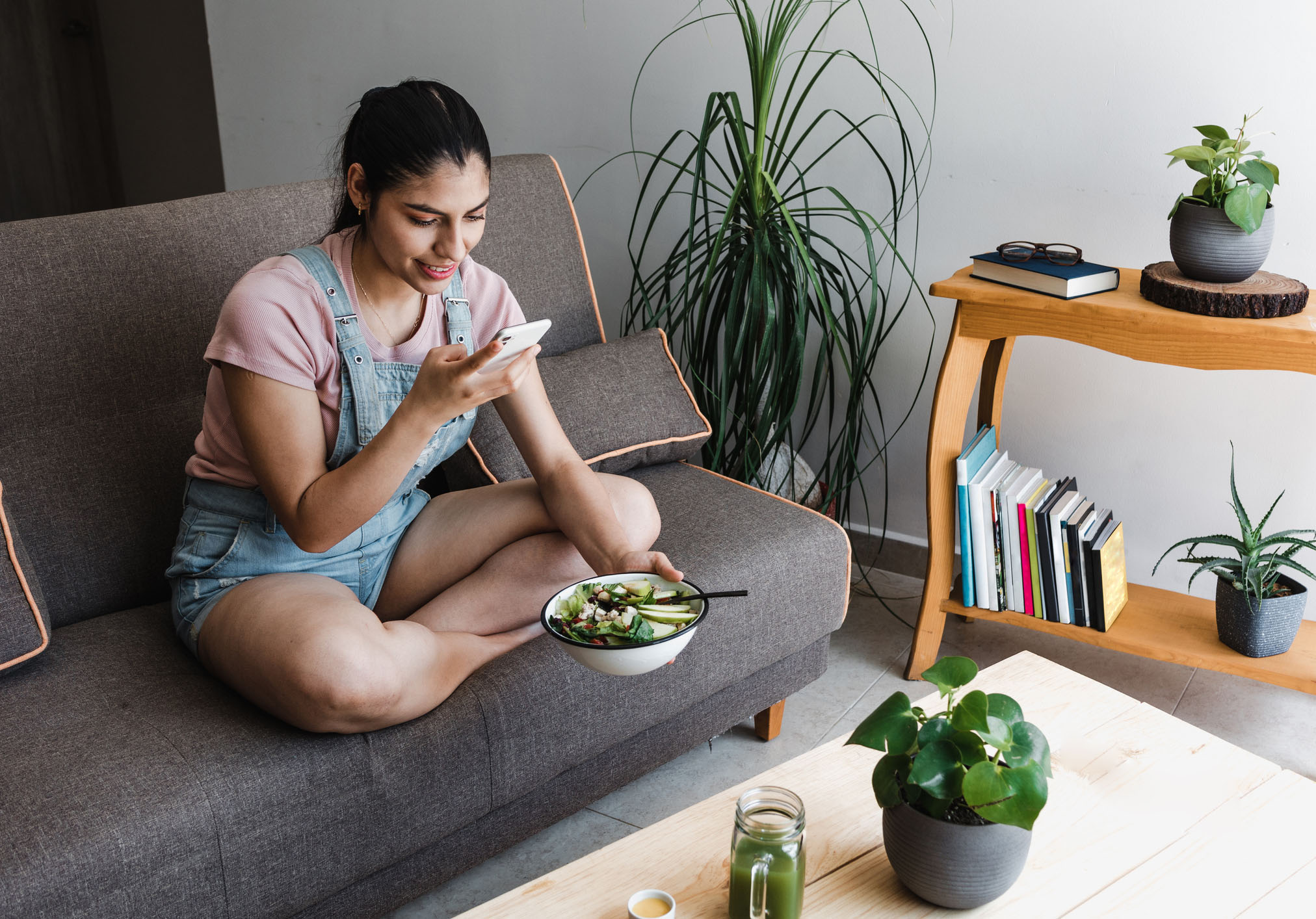 Chapter 4 of the Consumer outlook 2026 report shows a woman looking at her phone