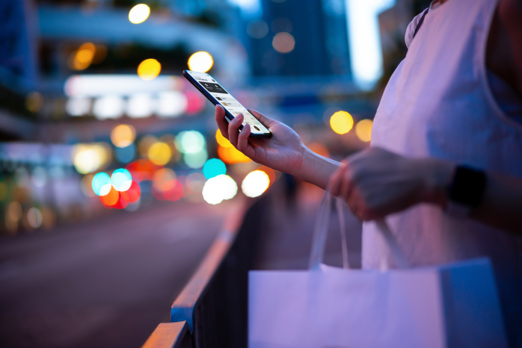 girl with a paper bag and her smartphone