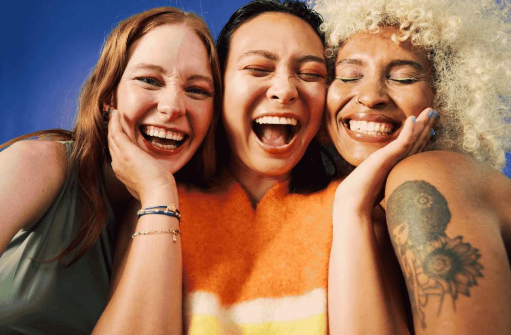 group of girls smiling in a beauty background